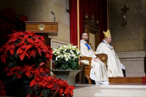 Archbishop Bernard Hebda, right, of Saint Paul and Minneapolis, celebrates a rare New Year’s Eve Mass attended just before midnight in St. Paul, Minn., on Dec. 31, 2024 (AP Photo/Giovanna Dell’Orto)