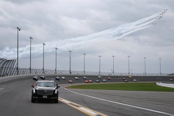 President Donald Trump rides in the presidential limousine known as "The Beast" as he takes a pace lap ahead of the start of the NASCAR Daytona 500 auto race at Daytona International Speedway, Sunday, Feb. 16, 2025, in Daytona Beach, Fla. (Chris Graythen/Pool via AP)