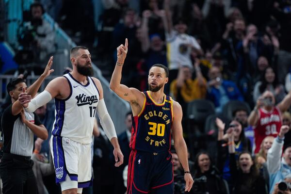 Golden State Warriors guard Stephen Curry (30) reacts after making a 3-point basket during the first half of an NBA basketball game against the Sacramento Kings, Thursday, March 13, 2025, in San Francisco. (AP Photo/Godofredo A. Vásquez)