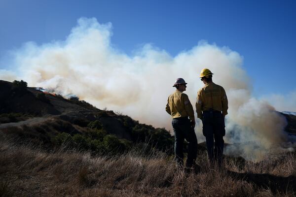 Fire crews monitor the Palisades Fire in the outskirts of the Pacific Palisades neighborhood of Los Angeles, Friday, Jan. 10, 2025. (AP Photo/Eric Thayer)