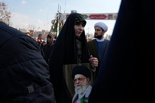 A woman holds a poster of the Iranian Supreme Leader Ayatollah Ali Khamenei during a rally commemorating the anniversary of the 1979 Islamic Revolution that toppled the late pro-U.S. Shah Mohammad Reza Pahlavi and brought Islamic clerics to power, in Tehran, Iran, Monday, Feb. 10, 2025. (AP Photo/Vahid Salemi)