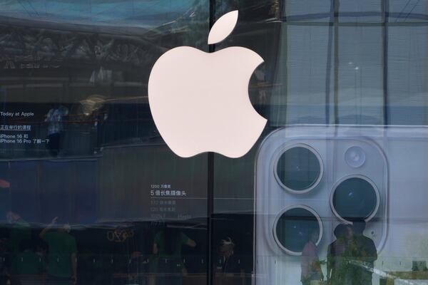 People visit an Apple store promoting its iPhone 16 at an outdoor shopping mall in Beijing, Sunday, May 11, 2025. (AP Photo/Andy Wong)