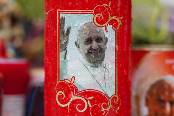 A candle for Pope Francis is seen in front of the Agostino Gemelli Polyclinic, in Rome, Wednesday, March 12, 2025, where the pontiff is hospitalized since Friday, Feb. 14. (AP Photo/Andrew Medichini)