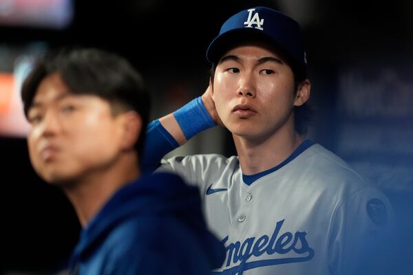 Los Angeles Dodgers' Hyeseong Kim stands in the dugout in the ninth inning of a baseball game against the Atlanta Braves, Sunday, May 4, 2025, in Atlanta. (AP Photo/Mike Stewart)