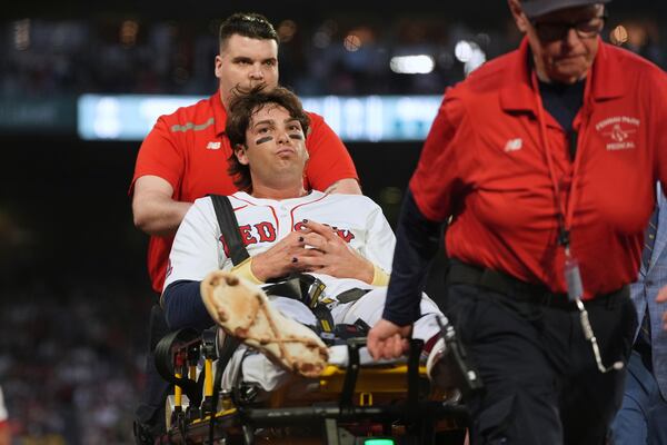 Boston Red Sox's Triston Casas is transported off the field on a stretcher after an apparent injury during the second inning of a baseball game against the Minnesota Twins at Fenway Park, Friday, May 2, 2025, in Boston. (AP Photo/Charles Krupa)