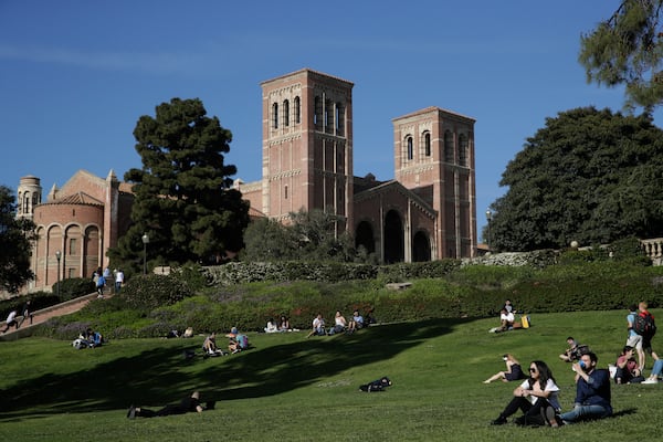 FILE - Students sit on the lawn near Royce Hall at the University of California, Los Angeles, in the Westwood section of Los Angeles on April 25, 2019. (AP Photo/Jae C. Hong, File)