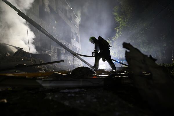 A rescuer works on a site of a residential building destroyed by a Russian strike in Zaporizhzhia, Ukraine, Thursday, May 1, 2025. (AP Photo/Kateryna Klochko)