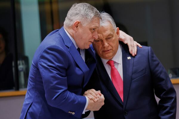 Slovakia's Prime Minister Robert Fico, left, speaks with Hungary's Prime Minister Viktor Orban during a round table meeting at an EU summit in Brussels, Thursday, March 20, 2025. (AP Photo/Omar Havana)