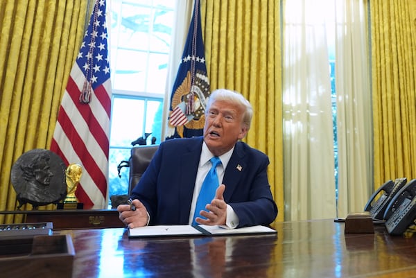 President Donald Trump speaks to reporters as he signs executive orders in the Oval Office of the White House, Tuesday, Feb. 4, 2025, in Washington. (AP Photo/Evan Vucci)