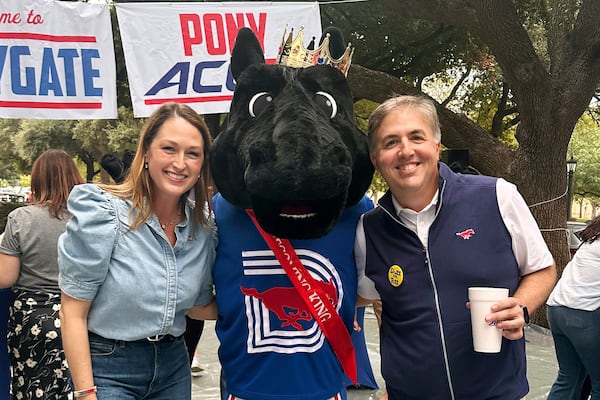 In this image provided by Lily Howard, Laura Howard, left, and Will Howard pose with SMU mascot Peruna during a tailgate event, Saturday, Nov. 2, 2024, prior to an NCAA college football game in Dallas. (Lily Howard via AP)