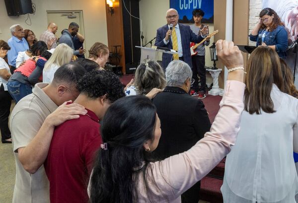 Rev. Esteban Rodriguez leads his congregants in prayer at the Centro Cristiano El Pan de Vida, a mid-size Church of God of Prophecy congregation, in Kissimmee, Fla., Sunday, Feb. 2, 2025. (AP Photo/Alan Youngblood)