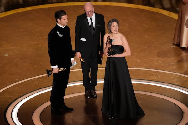 Clement Ducol, from left, Jacques Audiard, and Camille accept the award for best original song for "El Mal" from" Emilia Perez" during the Oscars on Sunday, March 2, 2025, at the Dolby Theatre in Los Angeles. (AP Photo/Chris Pizzello)