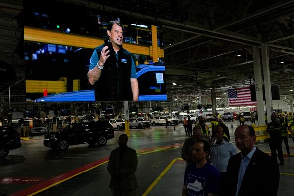 Jim Farley, President and Chief Executive Officer of Ford, is seen on a large monitor as he speaks at the Ford Motor Company Kentucky Truck Plant to launch the 2025 Ford Expedition, Wednesday, April 30, 2025, in Louisville, Ky. (AP Photo/Carolyn Kaster)