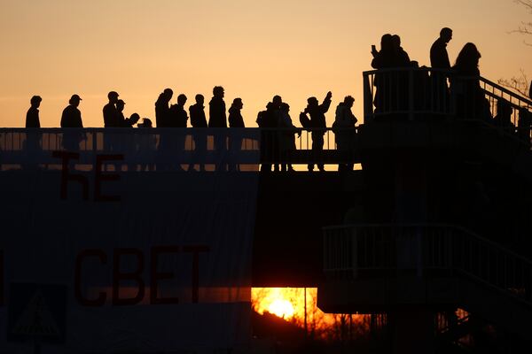 People walk across a bridge as they join a protest over the collapse of a concrete canopy that killed 15 people more than two months ago, in Novi Sad, Serbia, Saturday, Feb. 1, 2025. (AP Photo/Armin Durgut)