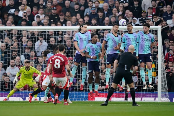 Manchester United's Bruno Fernandes (8) scores his side's opening goal during the English Premier League soccer match between Manchester United and Arsenal at Old Trafford stadium in Manchester, England, Sunday, March 9, 2025. (AP Photo/Dave Thompson)