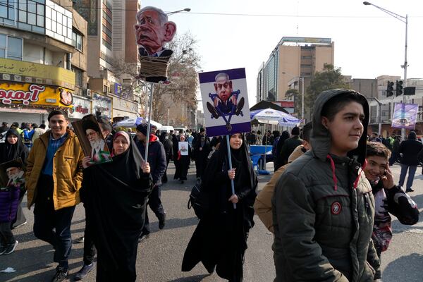 Iranian demonstrators carry caricatures of the Israeli Prime Minister Benjamin Netanyahu during a rally commemorating anniversary of 1979 Islamic Revolution that toppled the late pro-U.S. Shah Mohammad Reza Pahlavi and brought Islamic clerics to power, in Tehran, Iran, Monday, Feb. 10, 2025. (AP Photo/Vahid Salemi)