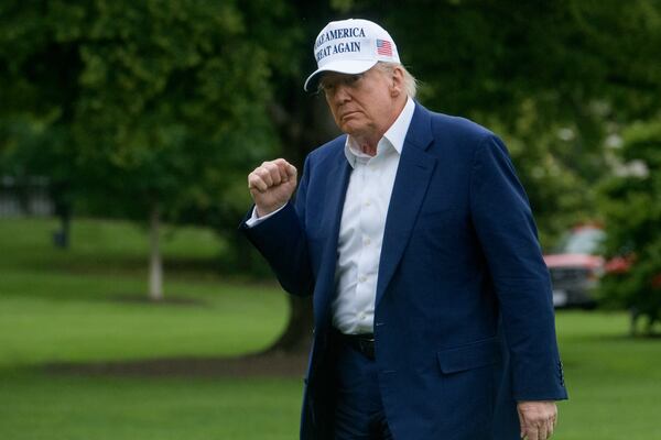 President Donald Trump acknowledges reporters as he disembarks Marine One upon arrival on the South Lawn of the White House in Washington, Sunday, May 25, 2025. (AP Photo/Rod Lamkey, Jr.)
