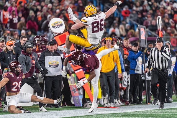 Minnesota tight end Jameson Geers (86) goes over Virginia Tech cornerback Dante Lovett (1) during the first half of the Duke's Mayo Bowl NCAA college football game Friday, Jan. 3, 2025, in Blacksburg, Va. (AP Photo/Robert Simmons)