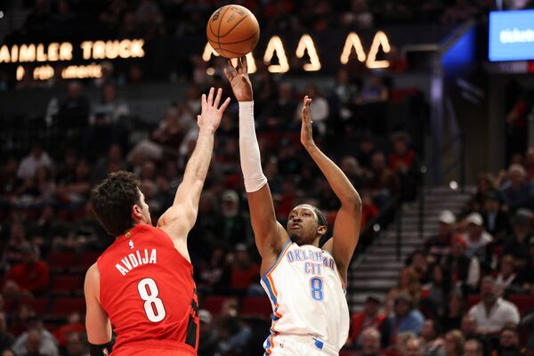 Oklahoma City Thunder forward Jalen Williams (8) shoots over Portland Trail Blazers forward Deni Avdija (8) during the first half of an NBA basketball game, Sunday, Jan. 26, 2025, in Portland, Ore. (AP Photo/Amanda Loman)