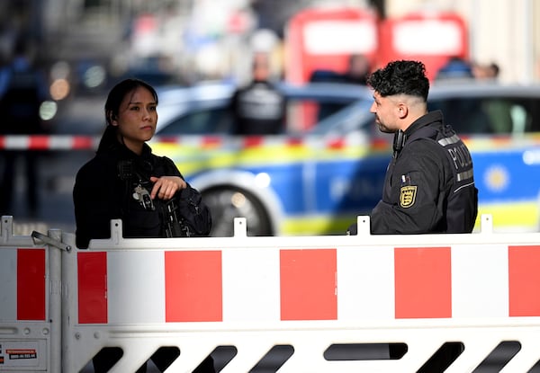 Police officers secure a street in the city center of Mannheim, Germany, Monday March 3, 2025, following an incident in which one person was killed and others injured when a car rammed into a crowd, German police said. (Boris Roessler/dpa via AP)