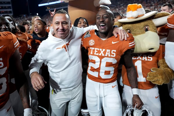 Texas head coach Steve Sarkisian celebrates with running back Quintrevion Wisner (26) after a first round game against Clemson in the College Football Playoff, Saturday, Dec. 21, 2024, in Austin, Texas. (AP Photo/Eric Gay)