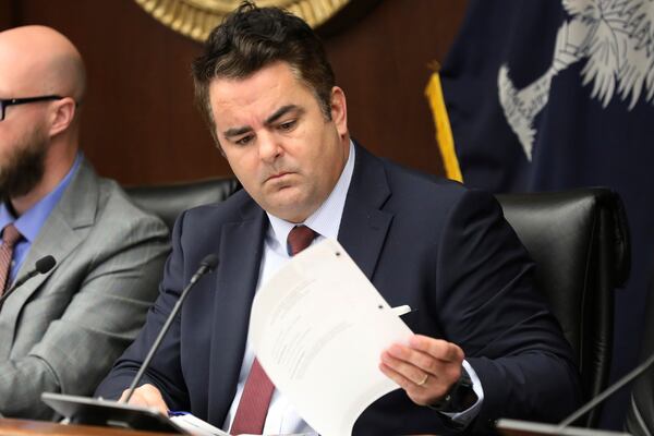 South Carolina Rep. Micah Caskey, R-Springdale, looks over papers during a Statehouse hearing on Wednesday, Jan. 29, 2025, in Columbia, S.C. (AP Photo/Jeffrey Collins)