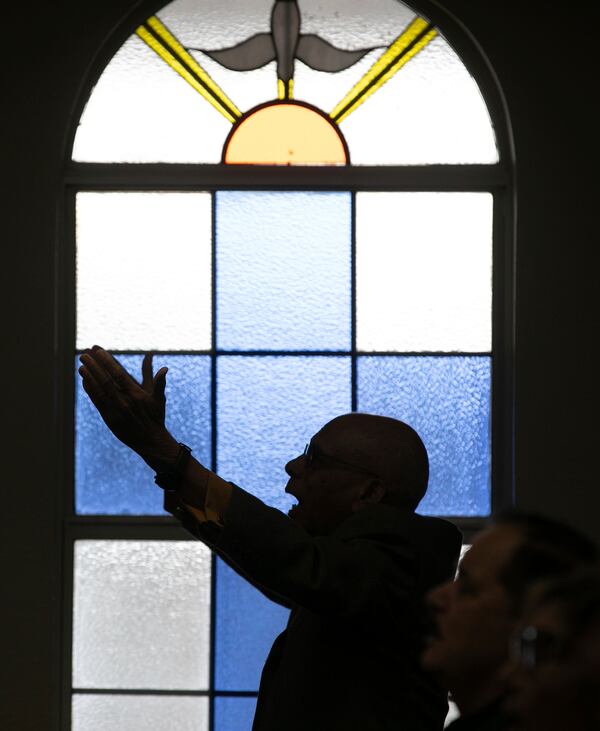 Carlos Der Rosario worships at Centro Cristiano El Pan de Vida, a mid-size Church of God of Prophecy congregation in Kissimmee, Florida, Sunday, Feb. 2, 2025. (AP Photo/Alan Youngblood)