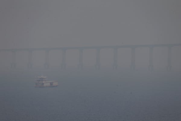 FILE - A boat navigates the Negro River amid smoke from wildfires in Manaus, Amazonas state, Brazil, Aug. 27, 2024. (AP Photo/Edmar Barros, File)