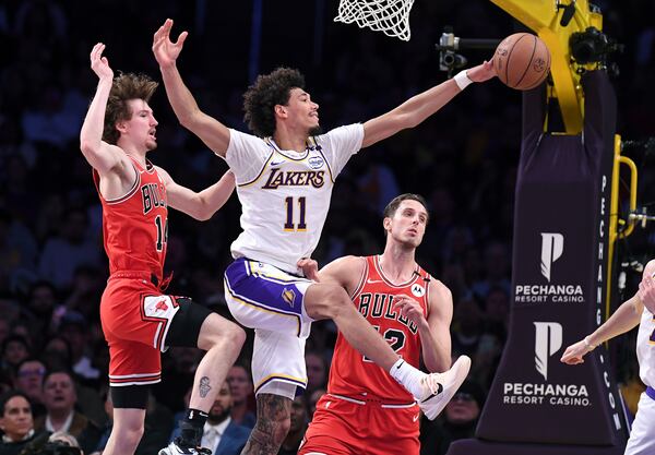 Los Angeles Lakers center Jaxson Hayes (11) battles for a rebound with Chicago Bulls forwards Matas Buzelis, left, and Zach Collins, third from left, in the first half of an NBA basketball game Saturday, March 22, 2025, in Los Angeles. (AP Photo/Wally Skalij)