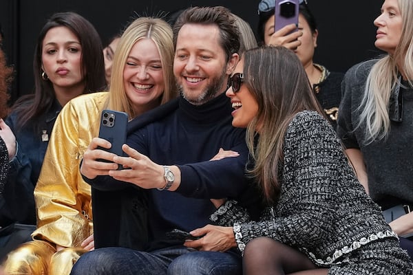 Dakota Fanning, from left, Derek Blasberg, and Jessica Alba attend the Chanel Fall/Winter 2025-2026 Womenswear collection presented Tuesday, March 11, 2025. in Paris. (Photo by Scott A Garfitt/Invision/AP)