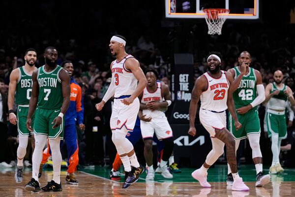 New York Knicks guard Josh Hart (3) and center Mitchell Robinson (23) celebrate after defeating the Boston Celtics in Game 2 of an NBA basketball second-round playoff series, Wednesday, May 7, 2025, in Boston. (AP Photo/Charles Krupa)