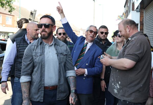 Reform UK leader Nigel Farage gestures as he campaigns with Reform UK mayoral candidate Andrea Jenkyns in Scunthorpe, England, Tuesday, April 29, 2025. (AP Photo/Darren Staples)