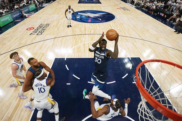 Minnesota Timberwolves forward Julius Randle (30) goes up for a shot as Golden State Warriors guard Buddy Hield (7) defends during the first half of Game 2 of an NBA basketball second-round playoff series, Thursday, May 8, 2025, in Minneapolis. (AP Photo/Abbie Parr)