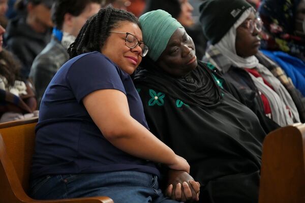 Metro Nashville council members Delishia Porterfield, left, and Zulfat Suara, right, console each other during a vigil for students that were killed and injured in a school shooting Wednesday, Jan. 22, 2025, in Nashville, Tenn. (AP Photo/George Walker IV)