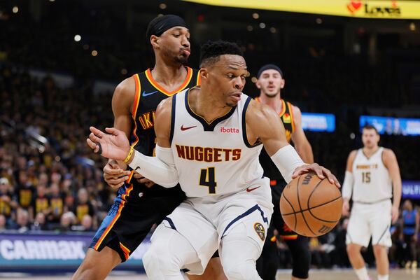 Denver Nuggets guard Russell Westbrook (4) works to get to the basket as Oklahoma City Thunder's Aaron Wiggins, rear, defends in the first half of Game 1 of an NBA basketball second-round playoff series Monday, May 5, 2025, in Oklahoma City. (AP Photo/Nate Billings)