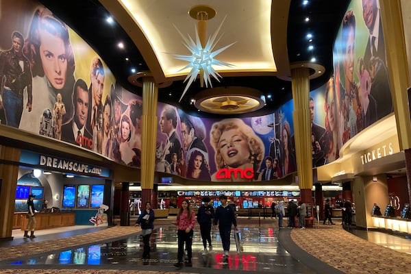 FILE - People walk in an AMC Theater in Paramus, New Jersey, on Monday, March 13, 2023. (AP Photo/Ted Shaffrey, File)