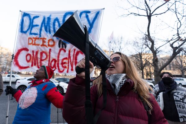 Carrie Muniak joins a rally in front of the Office of Personnel Management, Monday, Feb. 3, 2025, in Washington. President Donald Trump is relying on a relatively obscure federal agency to reshape government. The Office of Personnel Management was created in 1979 by President Jimmy Carter and is the equivalent of the government's human resources department. It helps manage the civil service, including pay schedules, health insurance and pension programs. The agency has offered millions of federal workers eight months of salary if they voluntarily choose to leave their jobs by Feb. 6. (AP Photo/Manuel Balce Ceneta)