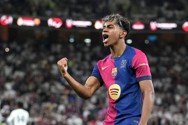 Barcelona's Lamine Yamal celebrates after scoring his side's opening goal during the Spain Super Cup final soccer match between Real Madrid and Barcelona at King Abdullah Stadium in Jeddah, Saudi Arabia, Sunday, Jan. 12, 2025. (AP Photo/Altaf Qadri)