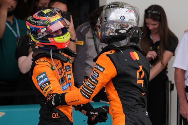 McLaren drivers Oscar Piastri of Australia, left, and Lando Norris of Britain celebrate after a first and second place finish in the Formula One Miami Grand Prix auto race Sunday, May 4, 2025, in Miami Gardens. Fla. (AP Photo/Rebecca Blackwell)