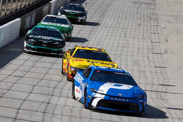 Denny Hamlin (11) leads Todd Gilliland (34) during a NASCAR Cup Series auto race, Sunday, April 13, 2025, in Bristol, Tenn. (AP Photo/Wade Payne)