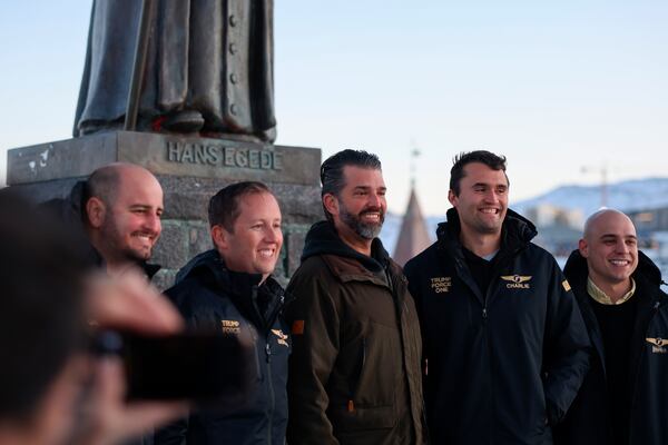 Donald Trump Jr., center, poses for a photo in front of Hans Egede statue as he arrives in Nuuk, Greenland, Tuesday, Jan. 7, 2025. (Emil Stach/Ritzau Scanpix via AP)