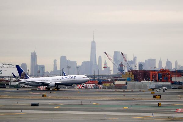 FILE - A United Airlines jet prepares touches down at Newark Liberty International Airport a day after a temporary grounding of aircraft was placed after reports of drones in the flight path, Wednesday, Jan. 23, 2019, in Newark, N.J. (AP Photo/Julio Cortez, File)