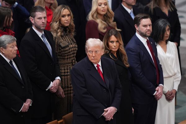 President Donald Trump, from front row left, first lady Melania Trump, Vice President JD Vance, his wife Usha Vance, and from back row left, Viktor Knavs, Eric Trump, Lara Trump and Tiffany Trump attend the national prayer service at the Washington National Cathedral, Tuesday, Jan. 21, 2025, in Washington. (AP Photo/Evan Vucci)