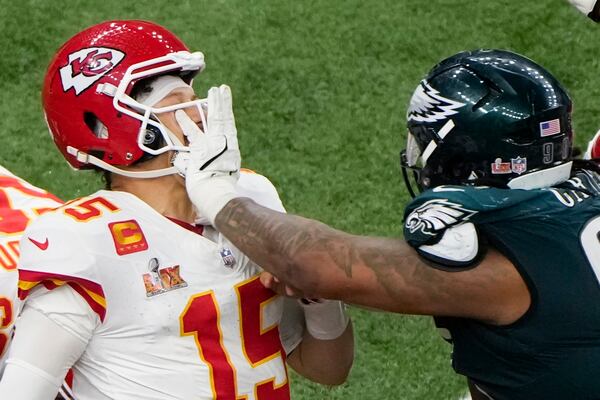 Philadelphia Eagles defensive tackle Jalen Carter (98) pushes Kansas City Chiefs quarterback Patrick Mahomes (15) during the second half of the NFL Super Bowl 59 football game, Sunday, Feb. 9, 2025, in New Orleans. (AP Photo/Charlie Riedel)