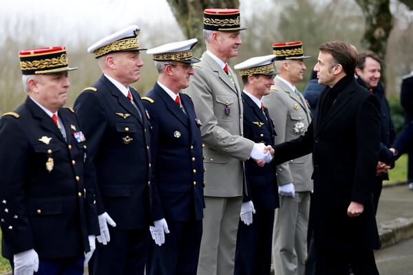 French President Emmanuel Macron shakes hands with General Pierre Schill during a military ceremony during a visit at the Digital Support and Cyber Command (CATNC) of the French Army as part of his New Year address to the Armed Forces, in Cesson-Sevigne, western France, Monday, Jan. 20, 2025. (Stephane Mahe/Pool via AP)