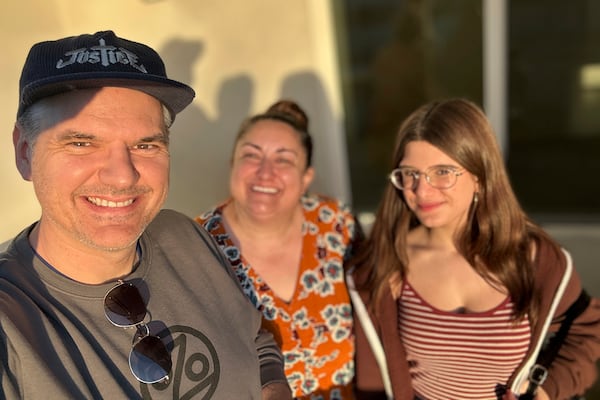 Ryan Pearson, a Los Angeles-based entertainment video editor for The Associated Press, left, takes a selfie with his wife Meg and daughter Reese in Glendale, Calif., as they tour new apartments Monday, Jan. 13, 2025. (AP Photo/Ryan Pearson)